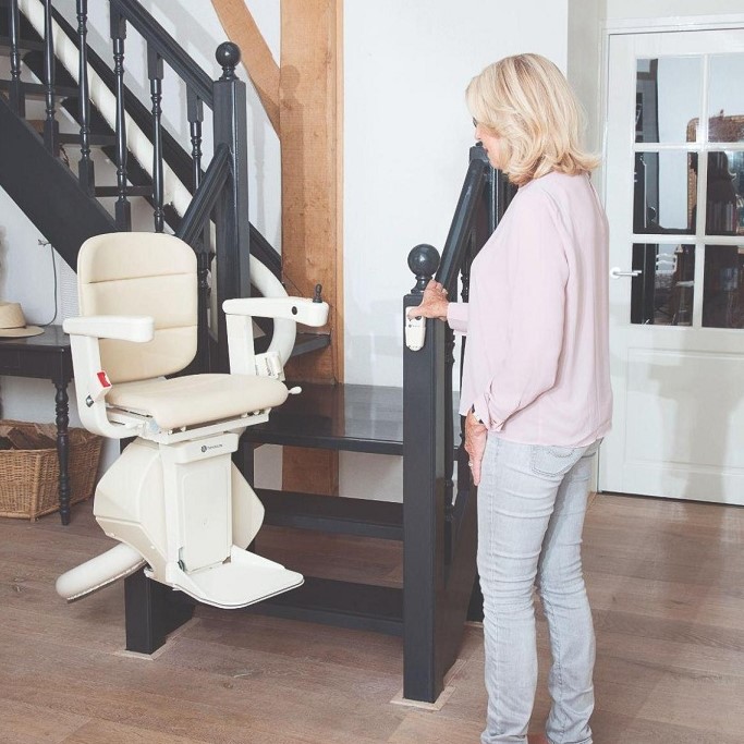 Lady Standing Next to Curved Indoor Stairlift