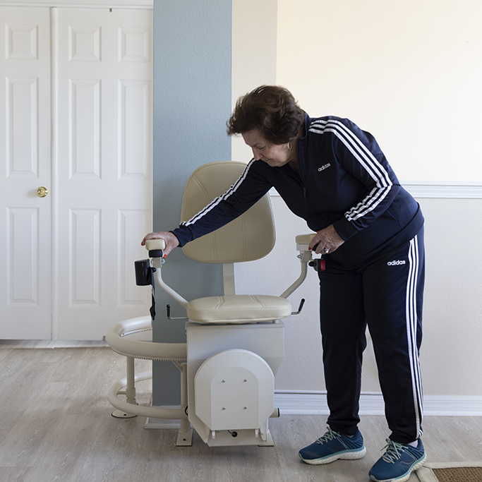 Lady Standing Next to Curved Indoor Stairlift
