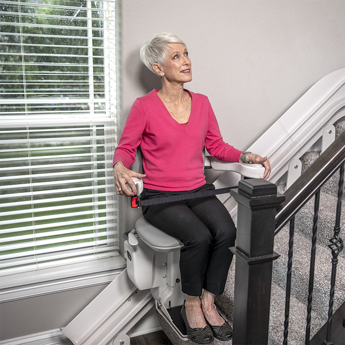 Lady riding curved stairlift