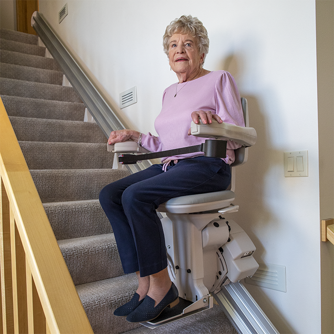 Lady riding straight stairlift