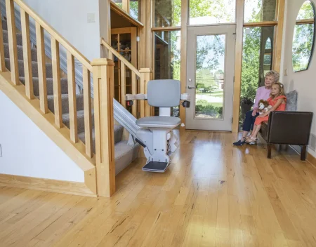 grandmother and grandchild sitting by the stairs